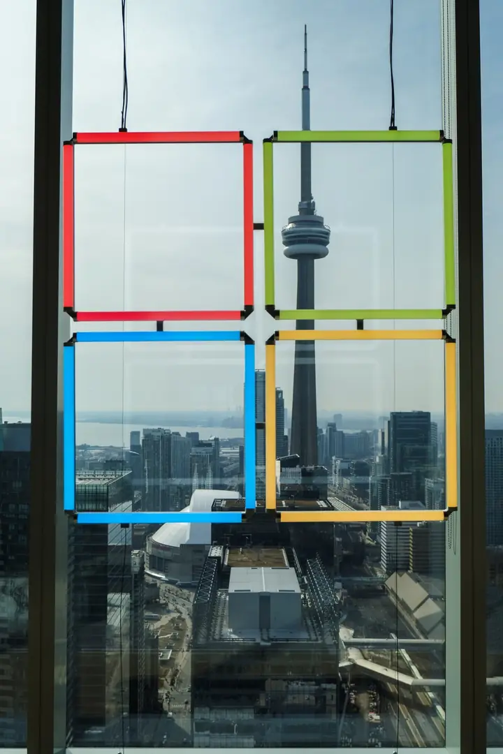 The CN Tower and the Rogers Centre seen through coloured window squares.